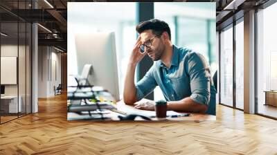 Stress, headache and frustrated business man working on computer in an office, annoyed and anxious. Male under pressure from a workload and deadline. Depressed guy experiencing burnout at work Wall mural