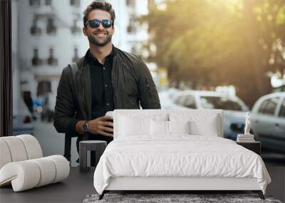 That urban feeling. Cropped shot of a handsome young man traveling through the city. Wall mural