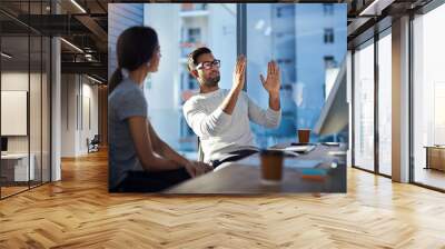 Turning his vision into reality. Shot of a young businessman explaining an idea to his coworker at work. Wall mural