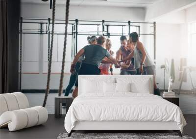 Were in this together. Shot of a fitness group working out at the gym. Wall mural