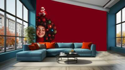 Christmas and New Year card concept. New Year is a beautiful happy girl with a hairstyle decorated with Christmas decorations. Santa Claus holds out a wrapped heart symbol of love from his hair. Wall mural