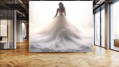 Bride with her back in flowing white wedding dress with long train in dreamy white background. Copy space. For wedding or fashion-related content., booklet and advertising of wedding salon dresses. Wall mural