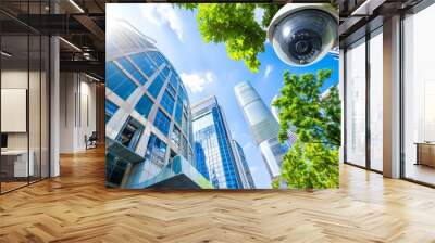 Modern skyscrapers with security camera on a sunny day. Concept of urban safety, city surveillance, contemporary architecture, high-rise buildings Wall mural