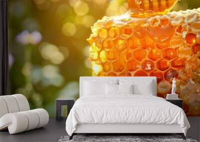 Sunlit honeycomb with dripping golden honey. Vibrant bokeh lush greenery backdrop. Concept of natural sweetener, organic food, and beekeeping products. Copy space Wall mural