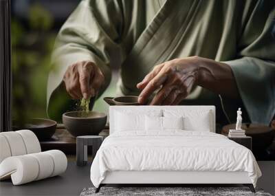 Traditional japanese tea ceremony. The hands of a tea master sprinkle matcha green tea into a cup to prepare a fragrant, healthy drink. Japanese culture and traditions Wall mural