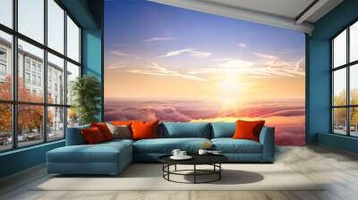 Beautiful aerial view above clouds with sunset. Wall mural