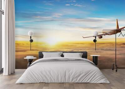 Commercial airplane flying above clouds Wall mural