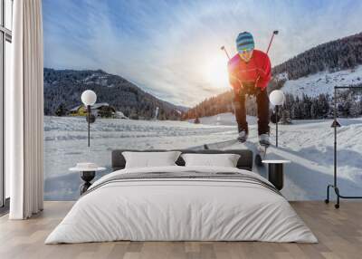 Cross-country skiing. Young man doing exercise Wall mural