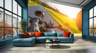 Driver riding motorcycle on an asphalt road Wall mural