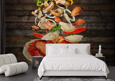 Flying ingredients with pizza dough, on wooden background Wall mural