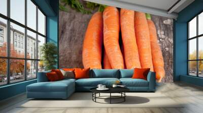 Fresh carrots on wooden table Wall mural