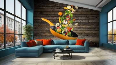 Fresh vegetables flying into a pan Wall mural