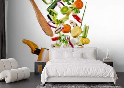 Fresh vegetables flying into a pot on white background Wall mural