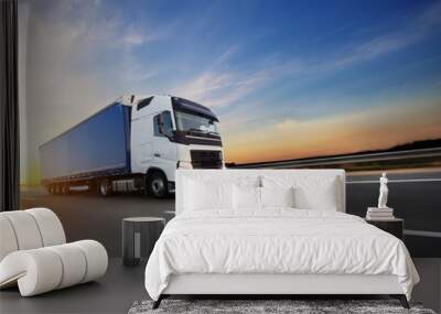 Loaded European truck on motorway in sunset Wall mural