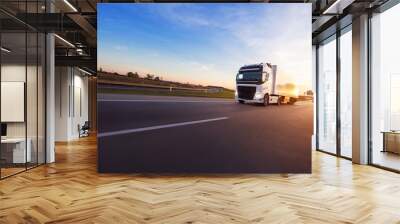 Loaded European truck on motorway in sunset Wall mural