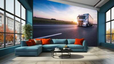 Loaded European truck on motorway in sunset Wall mural