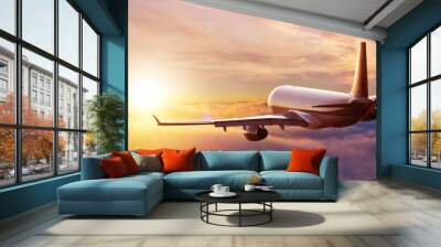 Passengers commercial airplane flying above clouds Wall mural