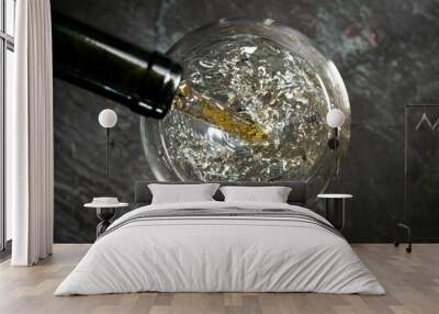 Pouring white wine into the glass, top shot. Wall mural