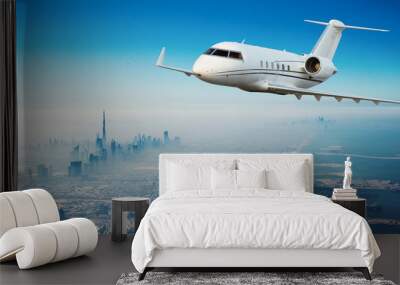 Private jet plane flying above Dubai city Wall mural