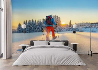 Snowshoe walker running in powder snow Wall mural