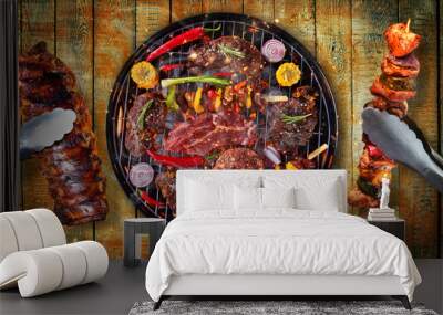 Top view of fresh meat and vegetable on grill placed on wooden planks Wall mural