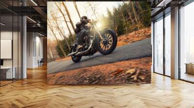 Young man riding chopper on road in forest Wall mural