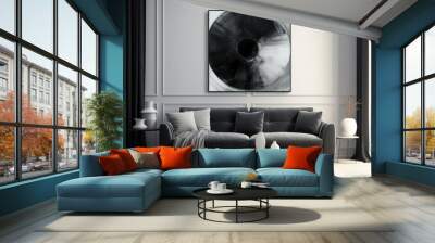 a cozy living room featuring a comfortable couch and a painting hanging on the wall in black and whi Wall mural