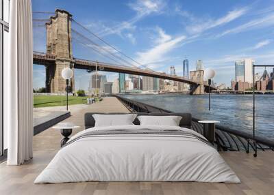 The famous Brooklyn bridge, from DUMBO, with the Manhattan financial district on the other side of the East river in New York city on a sunny day in the USA Wall mural