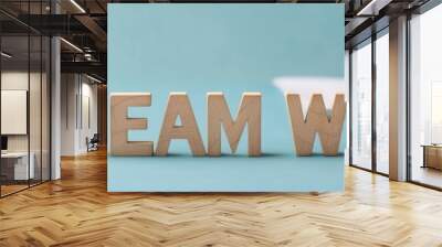 Teamwork concept with wooden letters and coffee cup on a desk. Wall mural