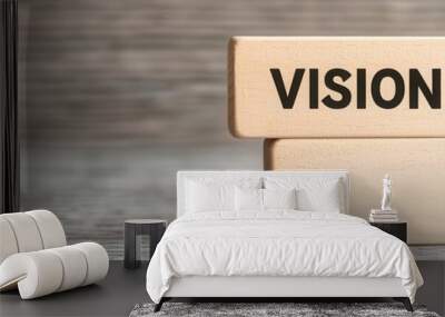 Wooden blocks displaying the word 'VISION' on a blurred wooden background. Wall mural