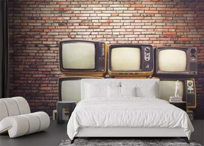 Antique and vintage style photo. retro televisions pile on floor in old room. Wall mural