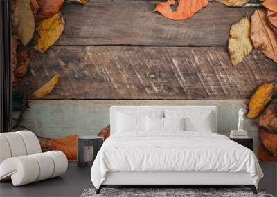 Autumn leaves over old wooden background with copy space. border frame design. Wall mural