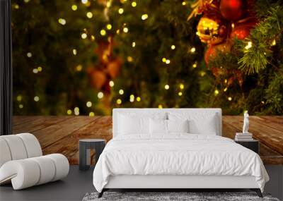 christmas and new year background with empty dark wooden deck table over christmas tree and blurred  Wall mural