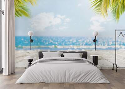 Top of wood table with seascape and palm leaves, blur bokeh light of calm sea and sky at tropical beach background. Empty ready for your product display montage.  summer vacation background concept. Wall mural