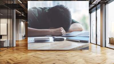 Burnout Syndrome, Man sleeping at his desk working over a laptop,Tried overworked, Freelance man working overload, Young business owner at home office,man feel tried and nap on desk. Wall mural