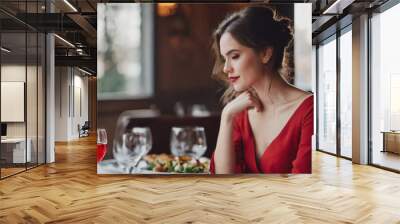 Beautiful brunette woman on a date in a restaurant with negative space Wall mural