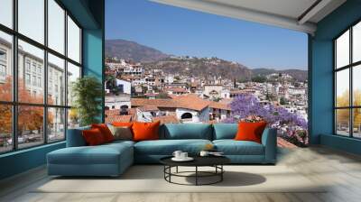 Impressive cityscape landscape of historical Taxco city with jacaranda tree in Mexico Wall mural