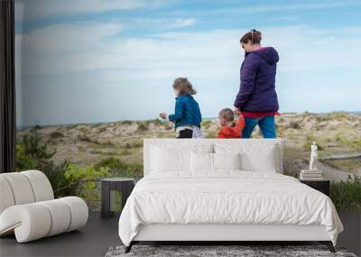 Family day out at coast sand dunes. Wall mural