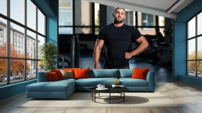 Handsome Man Posing In Black T-shirt Wall mural