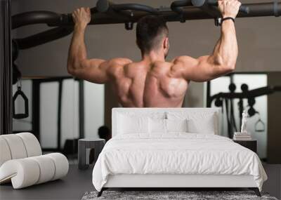 Male Athlete Doing Pull Ups Wall mural