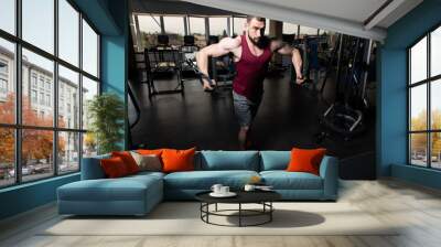 Young Man Exercising Chest In The Gym Wall mural