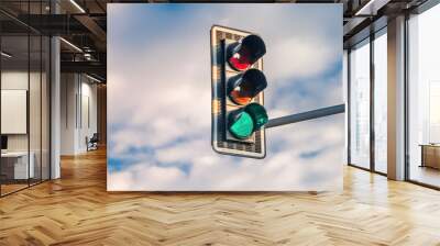 A traffic light with a green light on a background of a blue sky with white clouds. Banner Wall mural