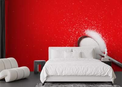 spoon with white sugar on a red background Wall mural