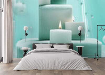 Mint green candles on soft white towels, a serene spa concept for relaxation and tranquility. 
 Wall mural