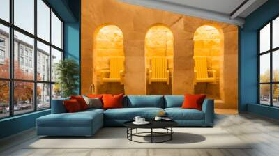 Yellow chairs in a stone room, minimalist and modern design, evoking tranquility and relaxation, perfect for a spa or wellness concept. 
 Wall mural