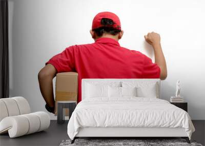 Asian delivery man or courier gesturing a knocking-the-door gesture, symbolizing delivering a package to the customer's front door, representing express delivery concept, isolated on white background Wall mural