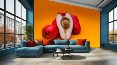 Jambu Bol or Jambu Jamaica isolated on orange background also known as Malay red rose Apple (Syzygium Malaccense). Wall mural