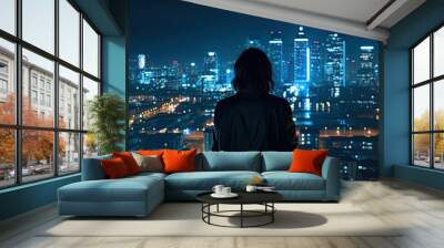 Bathed in the gentle glow of city lights, a woman stands on a balcony, taking in the mesmerizing nocturnal vista spread out before her. Wall mural