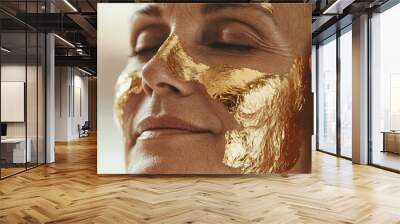 Woman with gold leaf face mask relaxing. Wall mural