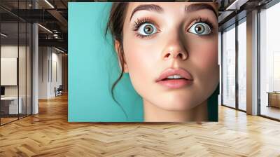 Woman with wide eyes, open mouth, and blue background. Wall mural